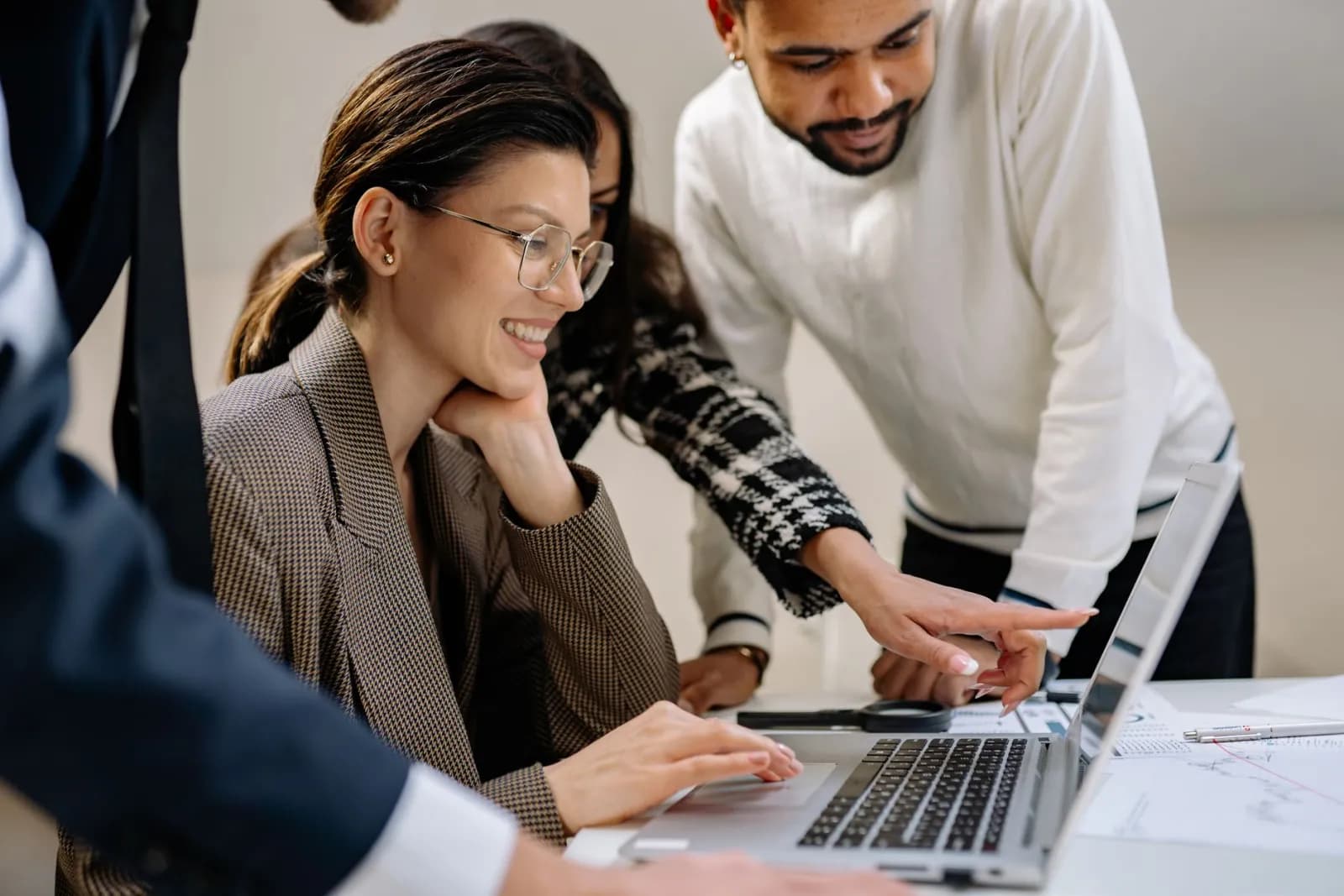 Two colleagues reviewing a social media post together on a laptop